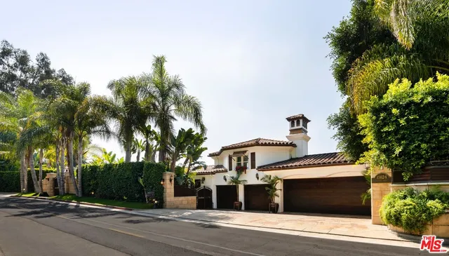 a front view of a building with tree s