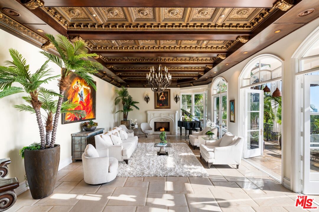 10824 Chalon Road Los Angeles, CA 90077 - Photo 8 of 40 a view of a patio with table and chairs potted plants and floor to ceiling window