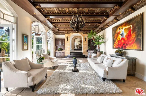 a living room with fireplace furniture and a large window