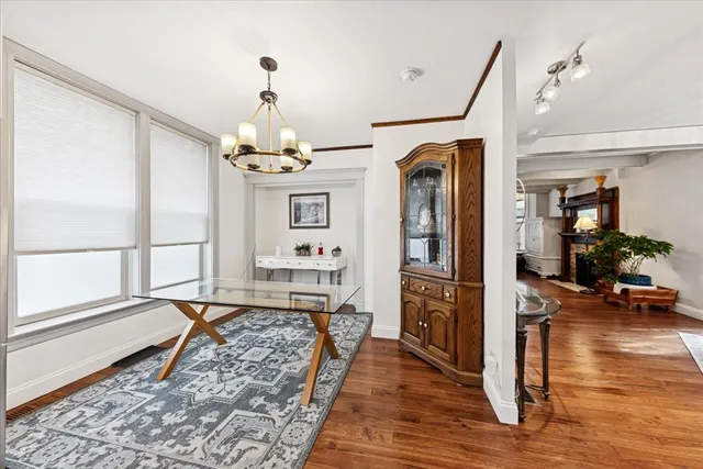 a very nice looking room with wooden floor and furniture