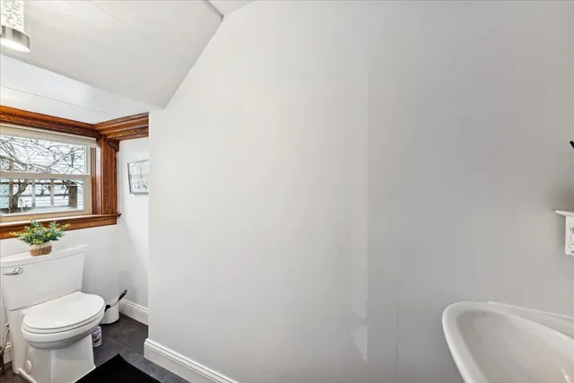 a white toilet sitting next to a window