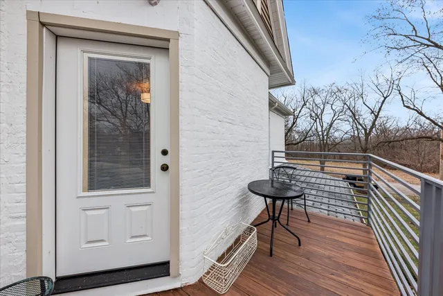 a view of a balcony with wooden floor and bench