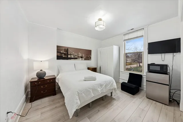 a bedroom with a bed and a television