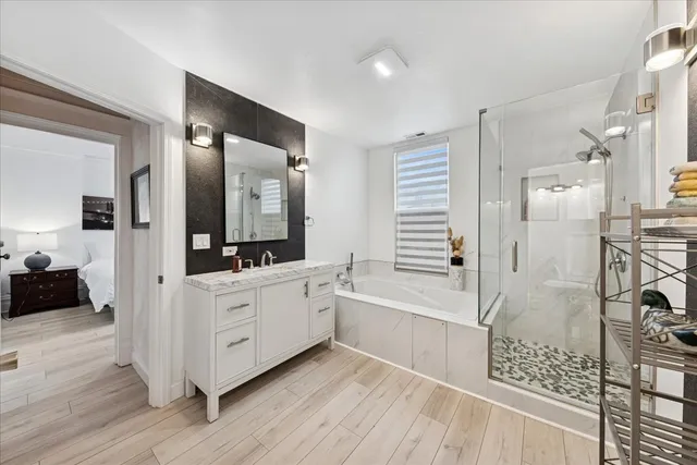a bathroom with a double vanity sink a mirror and shower