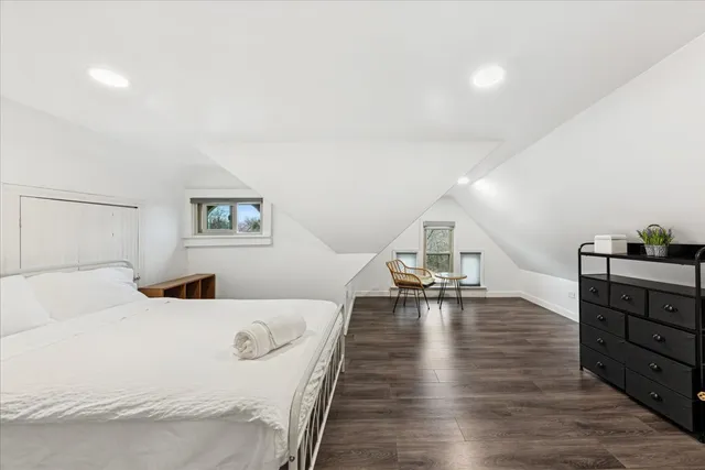 a bedroom with a bed and a table