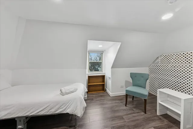 a bedroom with a bed and a chair