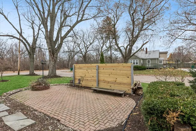 a view of a backyard with wooden fence