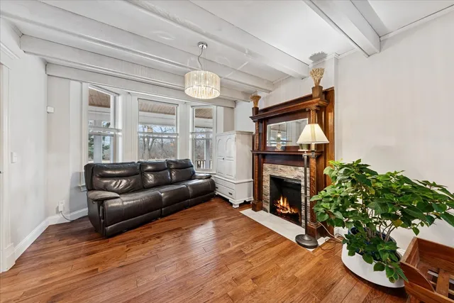 a living room with furniture fireplace and wooden floor