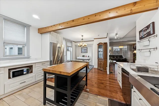 a large kitchen with stainless steel appliances granite countertop a lot of counter space and wooden floors