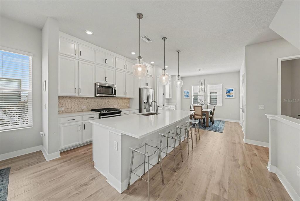 2511 North Grady Avenue, Unit 26 Tampa, FL 33607 - Photo 11 of 30 a kitchen with white cabinets and stainless steel appliances