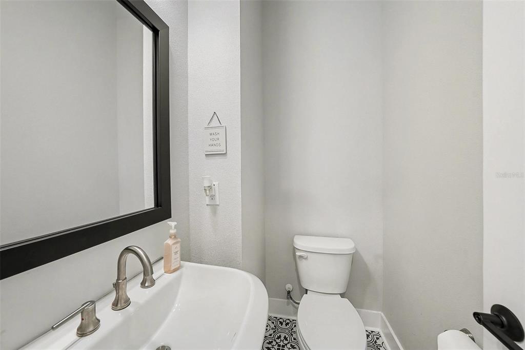 2511 North Grady Avenue, Unit 26 Tampa, FL 33607 - Photo 13 of 30 a bathroom with a toilet sink and mirror