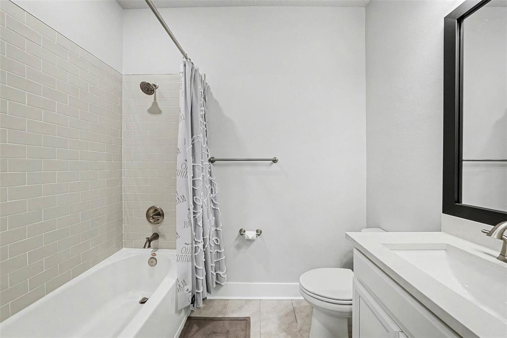 2511 North Grady Avenue, Unit 26 Tampa, FL 33607 - Photo 21 of 30 a bathroom with a sink a toilet and a bathtub