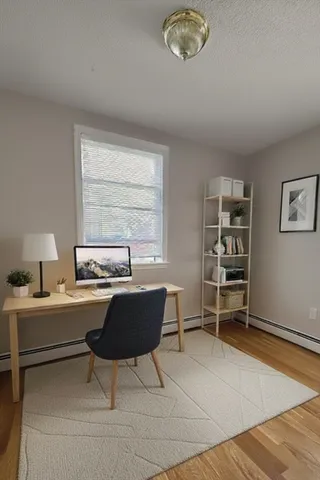 a workspace with furniture hardwood and a window