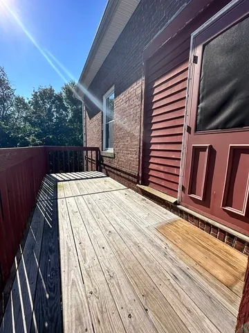 a utility room with dryer washer and a view of a room