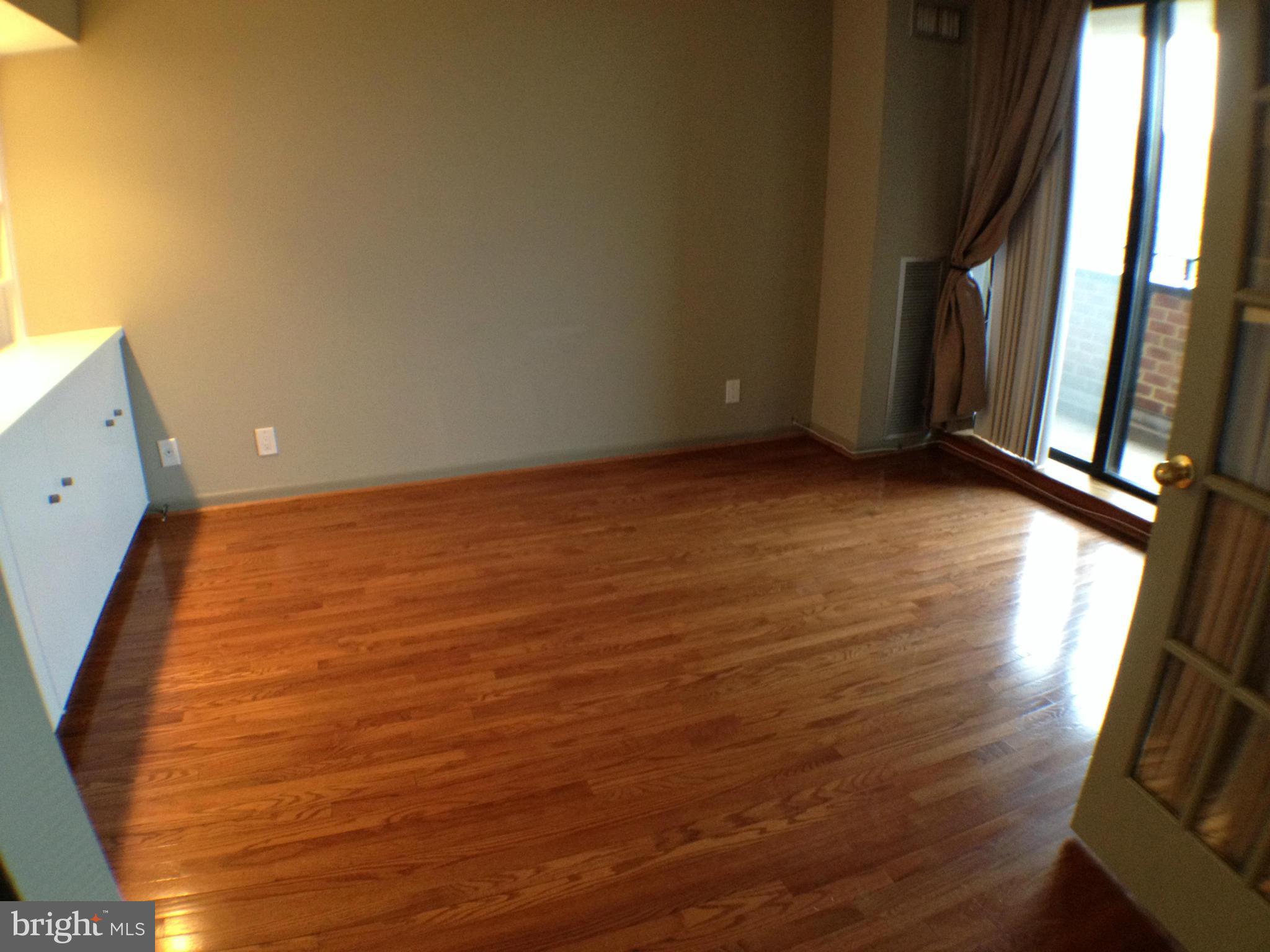 111 Hamlet Hill Road, Unit 902 Baltimore, MD 21210 - Photo 17 of 30 a view of a room with wooden floor and a window