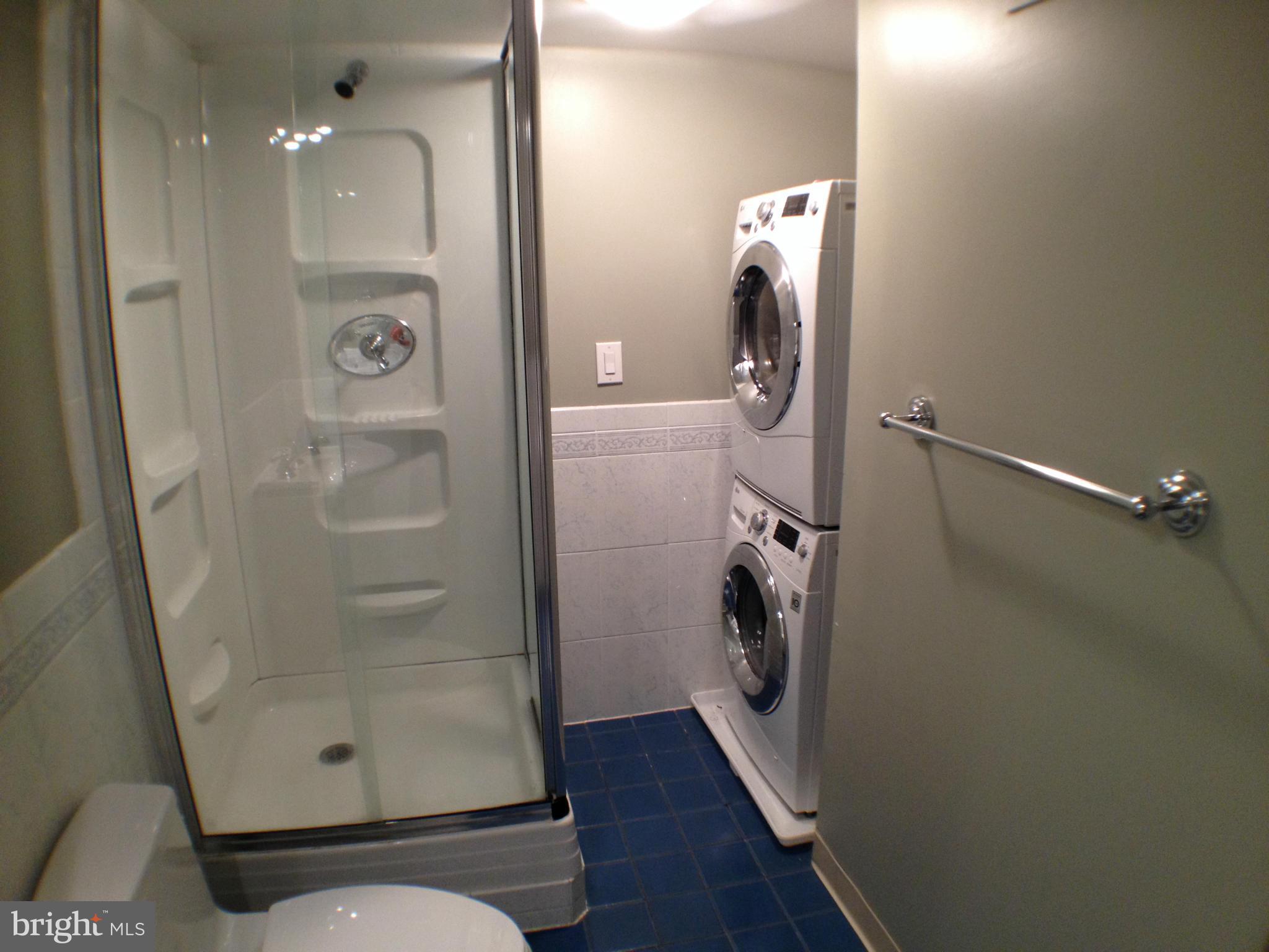111 Hamlet Hill Road, Unit 902 Baltimore, MD 21210 - Photo 25 of 30 a bathroom with a glass door shower a mirror