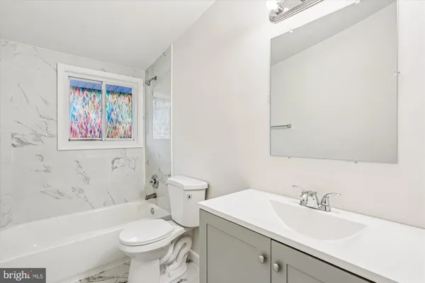 a bathroom with a sink toilet and bathtub