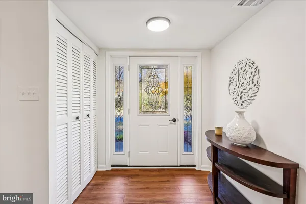 a view of an entryway with wooden floor