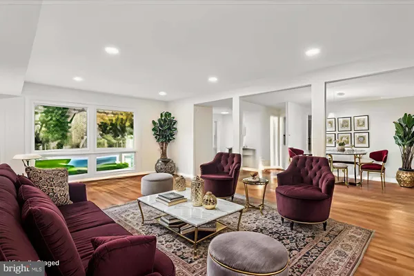 a living room with furniture potted plant and a large window