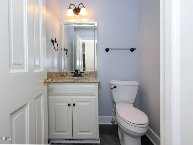 a kitchen with stainless steel appliances granite countertop a stove a sink and white cabinets