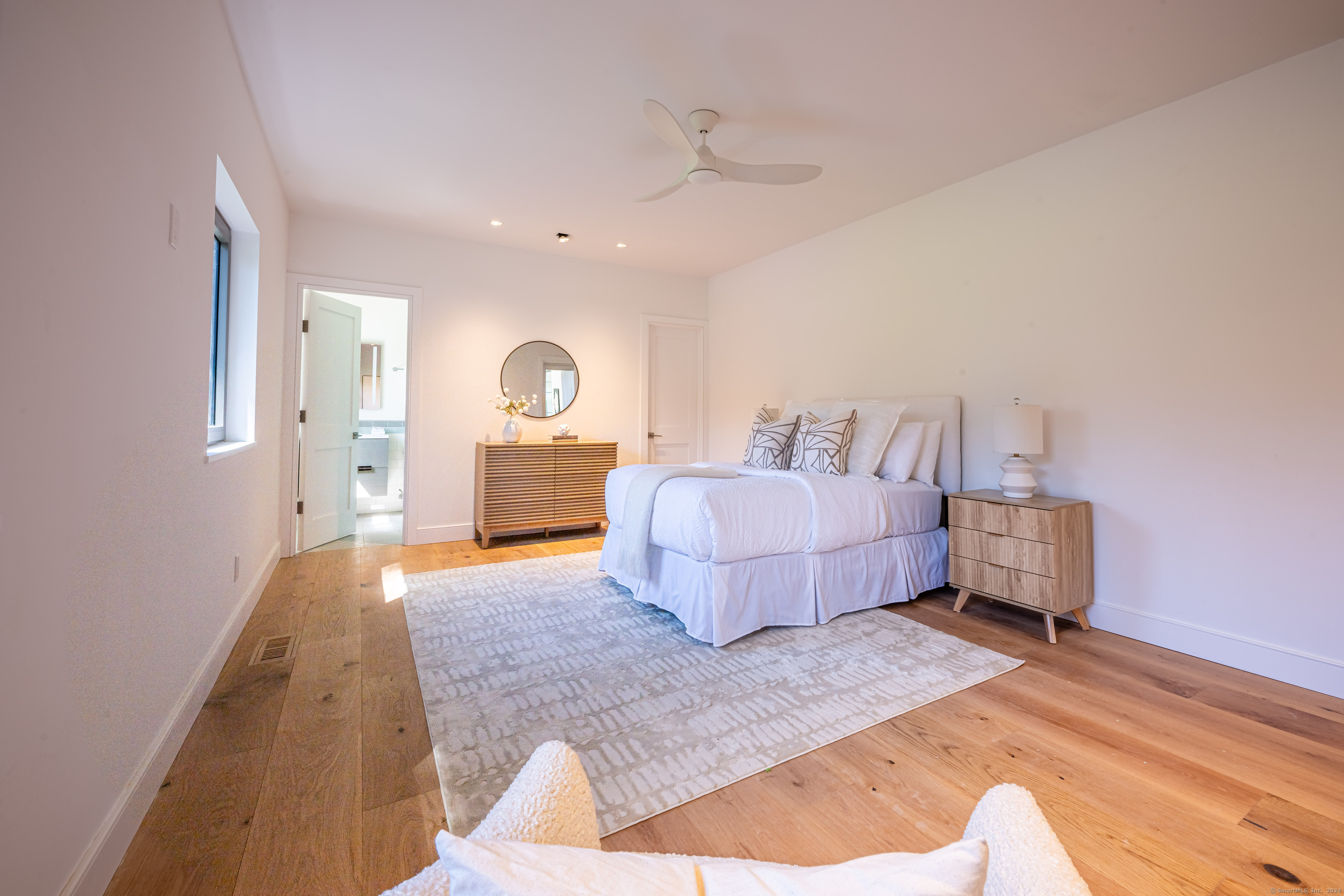 14 5 Mile River Road Darien, CT 06820 - Photo 17 of 21 a spacious bedroom with a bed and wooden floor