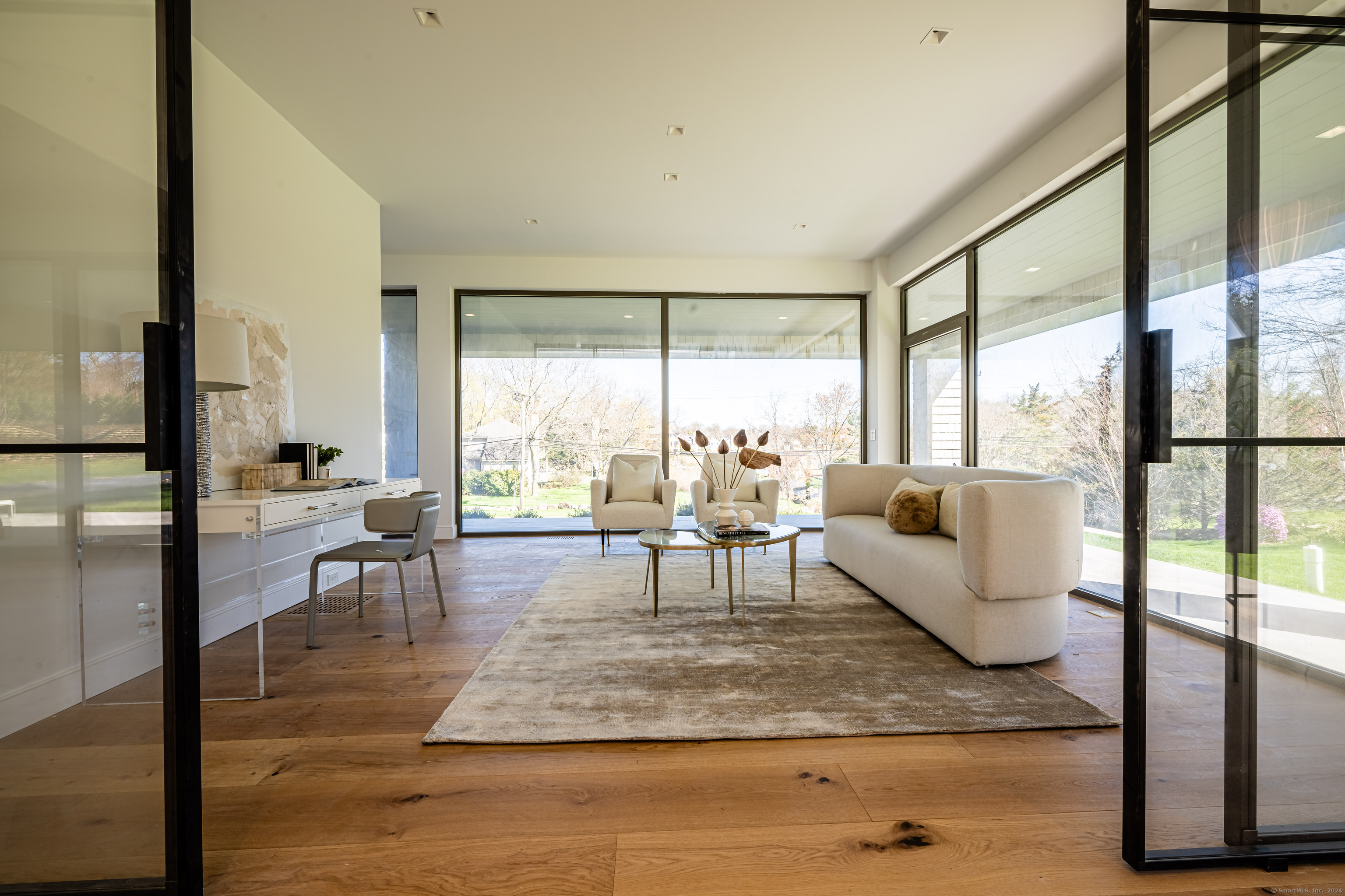 14 5 Mile River Road Darien, CT 06820 - Photo 6 of 21 a living room with furniture and a floor to ceiling window
