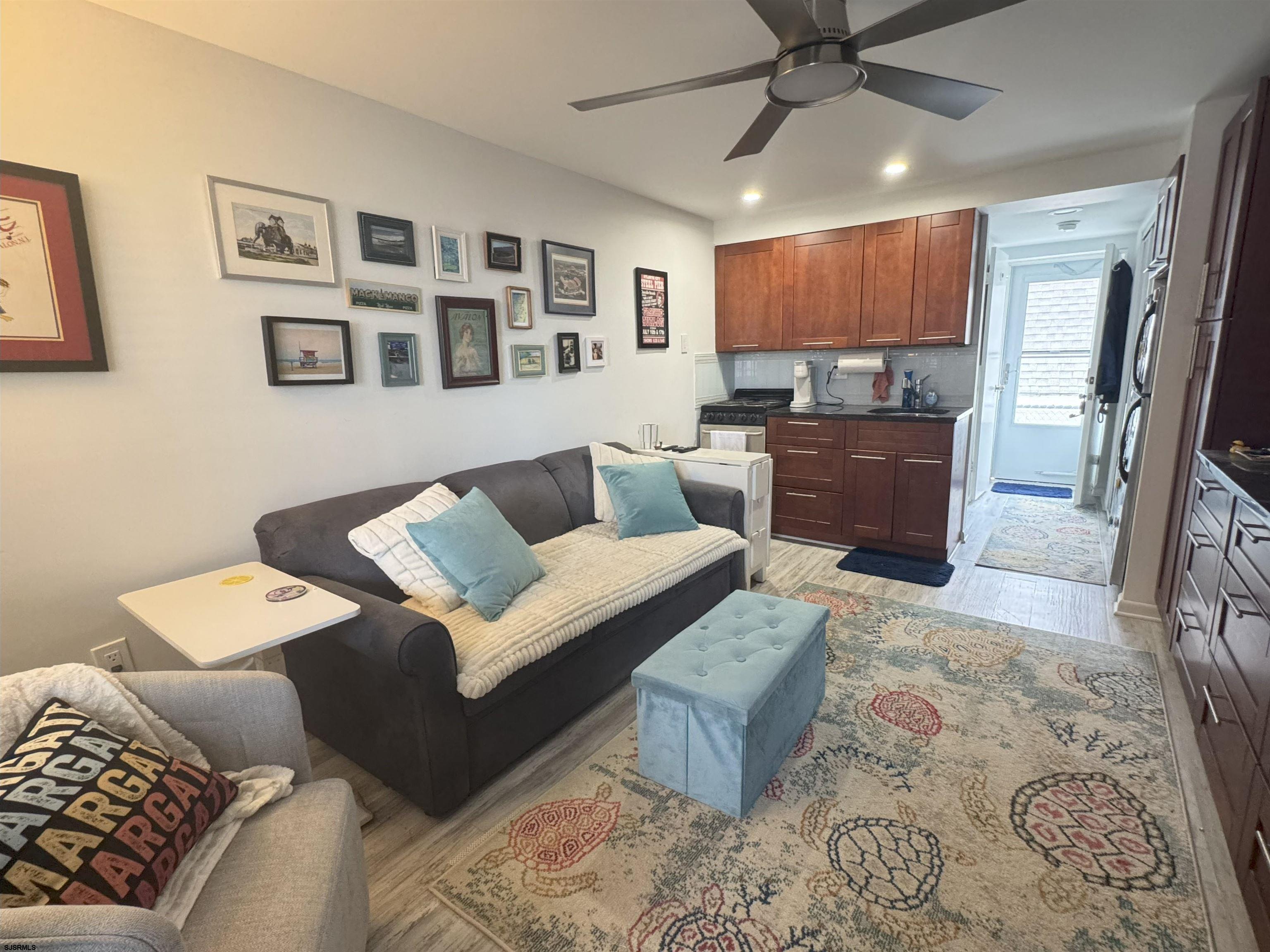 9201 Atlantic Avenue, Unit 18 Margate City, NJ 08402 - Photo 1 of 12 a living room with furniture and a wooden floor