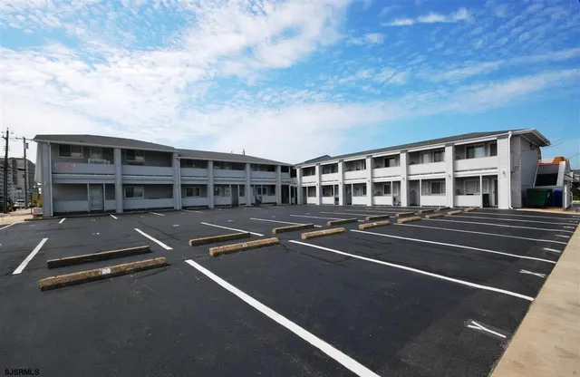 a view of a city that has lots of cars parked in front of it