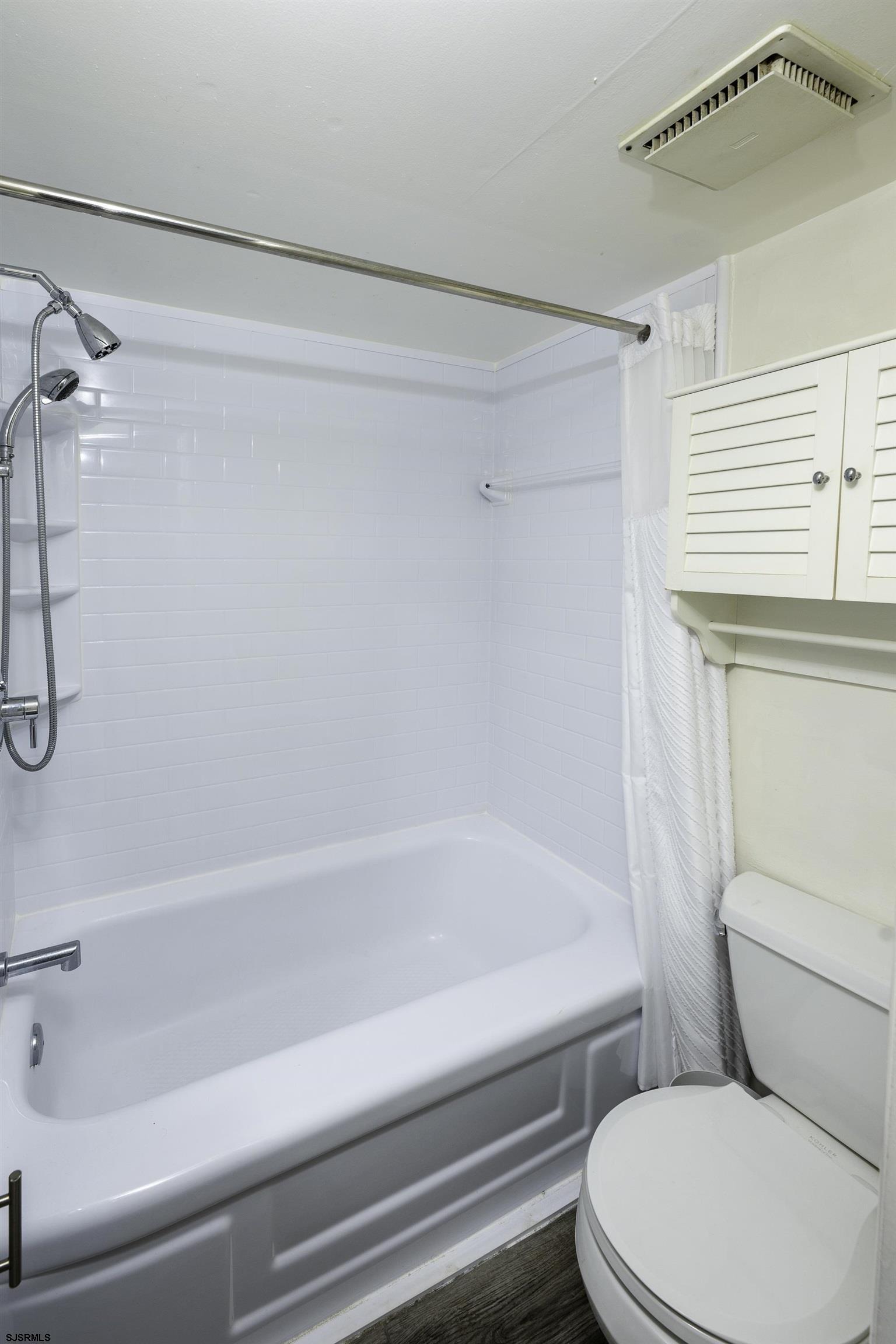 9201 Atlantic Avenue, Unit 18 Margate City, NJ 08402 - Photo 8 of 12 a bathroom with a toilet and a shower