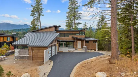 a front view of a house with a yard table and chairs