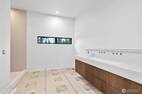 a bathroom with a shower and a sink