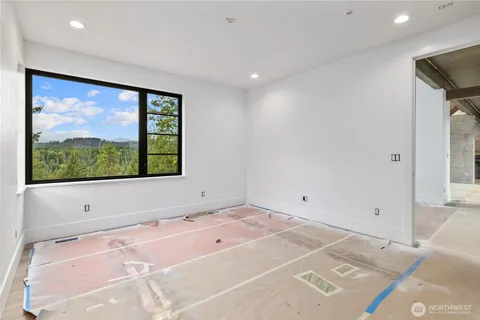 a bedroom with a bed and large window