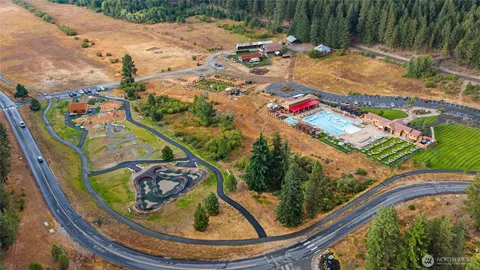 a front view of a house with a tree