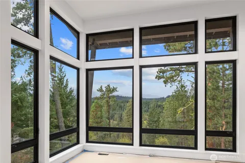 a large kitchen with stainless steel appliances a large counter top a stove a sink and a refrigerator