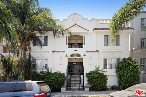 a front view of house with a garden