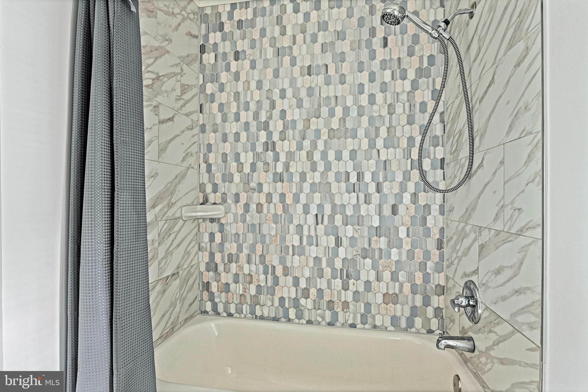13345 Point Rider Lane Herndon, VA 20171 - Photo 27 of 43 a bathroom with a bathtub and shower curtain