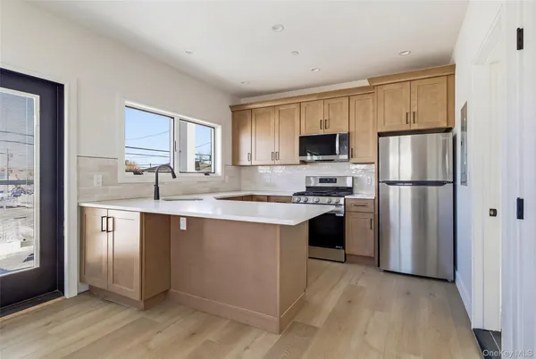 a kitchen with a refrigerator sink and cabinets