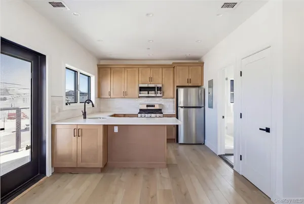 a kitchen with refrigerator cabinets and wooden floor
