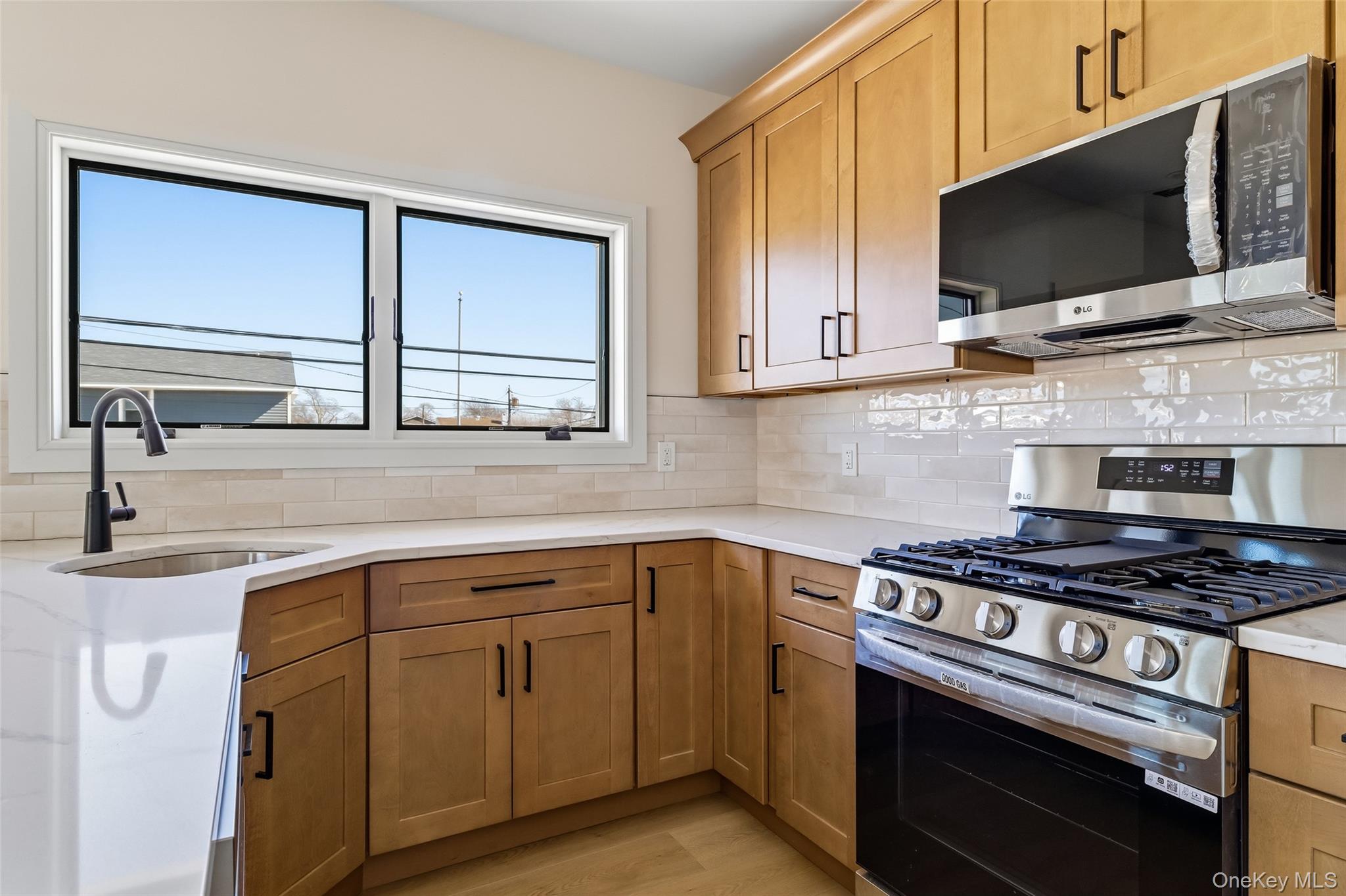 56 Suffolk Road Island Park, NY 11558 - Photo 7 of 14 a kitchen with cabinets appliances and a window