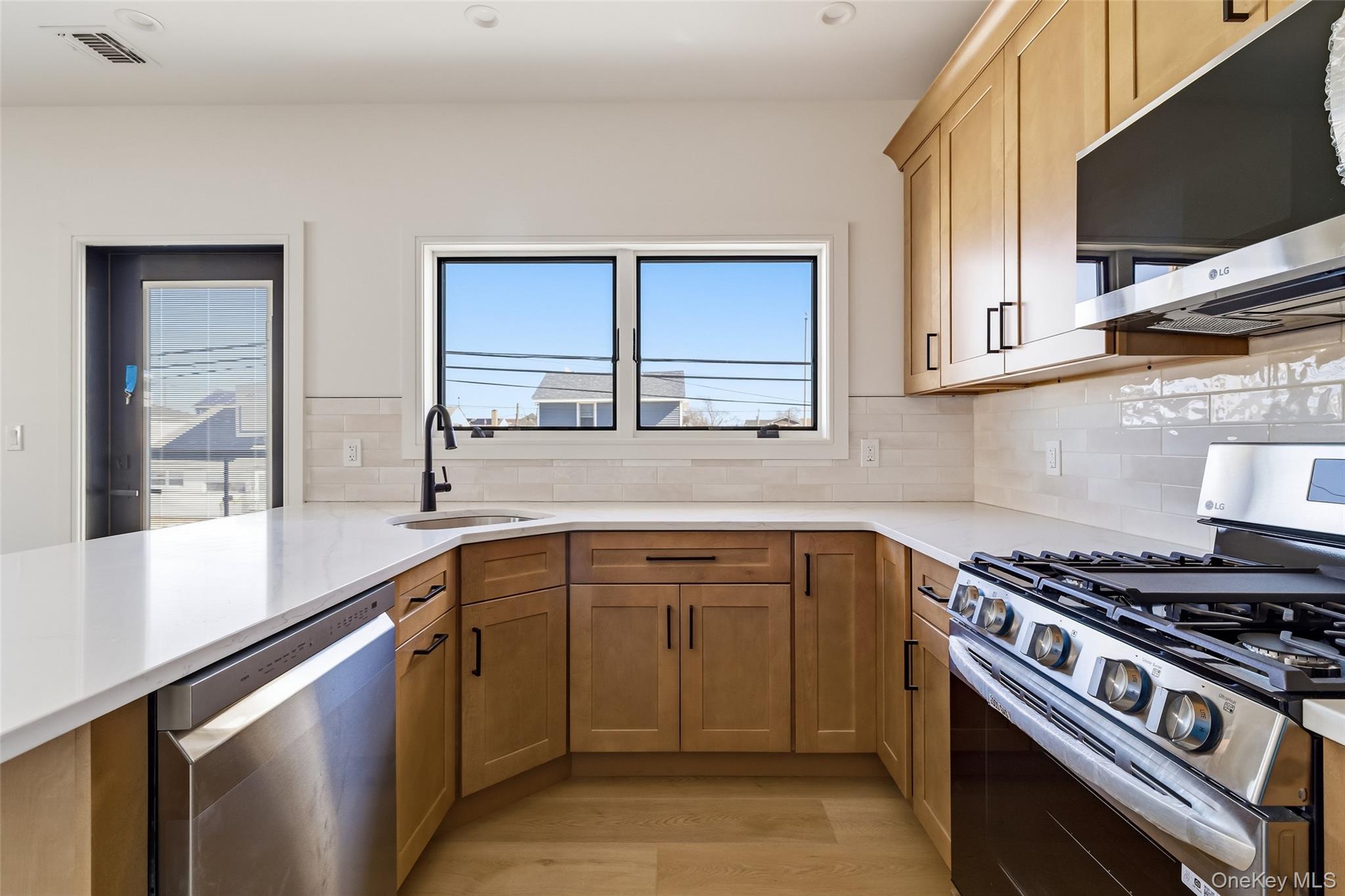 56 Suffolk Road Island Park, NY 11558 - Photo 8 of 14 a kitchen with a sink stove top oven and cabinets