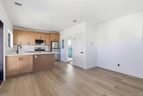 a kitchen with wooden floors and white appliances
