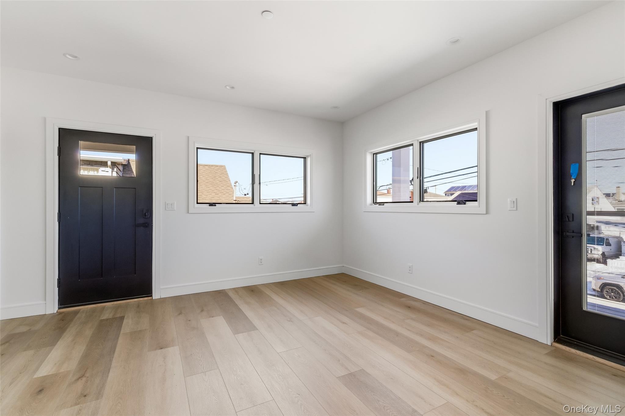 56 Suffolk Road Island Park, NY 11558 - Photo 10 of 14 a view of an empty room with wooden floor and a window