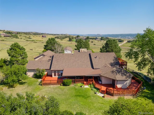 an aerial view of a house with garden space and outdoor seating