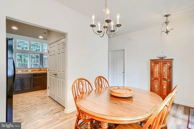 a kitchen with a stove a refrigerator and wooden cabinets