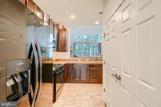 a large kitchen with kitchen island granite countertop a sink and a stove top oven with granite countertops