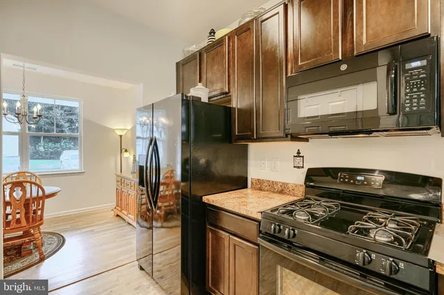 a kitchen with a refrigerator and a sink