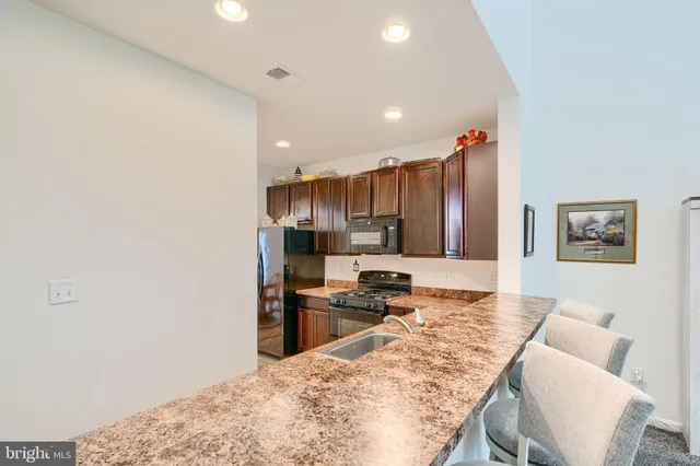 a bedroom with a bed and a flat tv screen on the dresser
