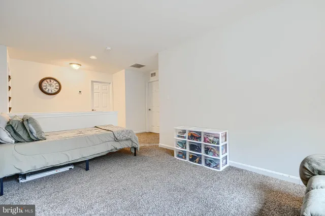 a bedroom with a bed and a television