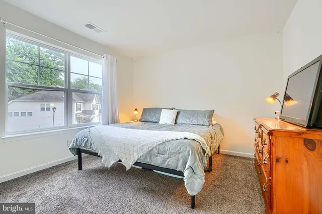 a bathroom with a sink vanity mirror and toilet