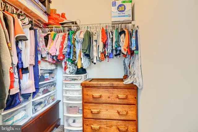a bathroom with a granite countertop sink mirror vanity and toilet